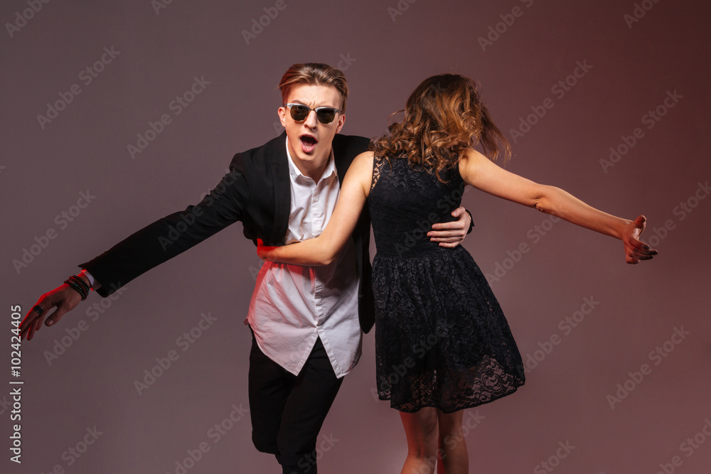 Happy young couple dancing and whirling