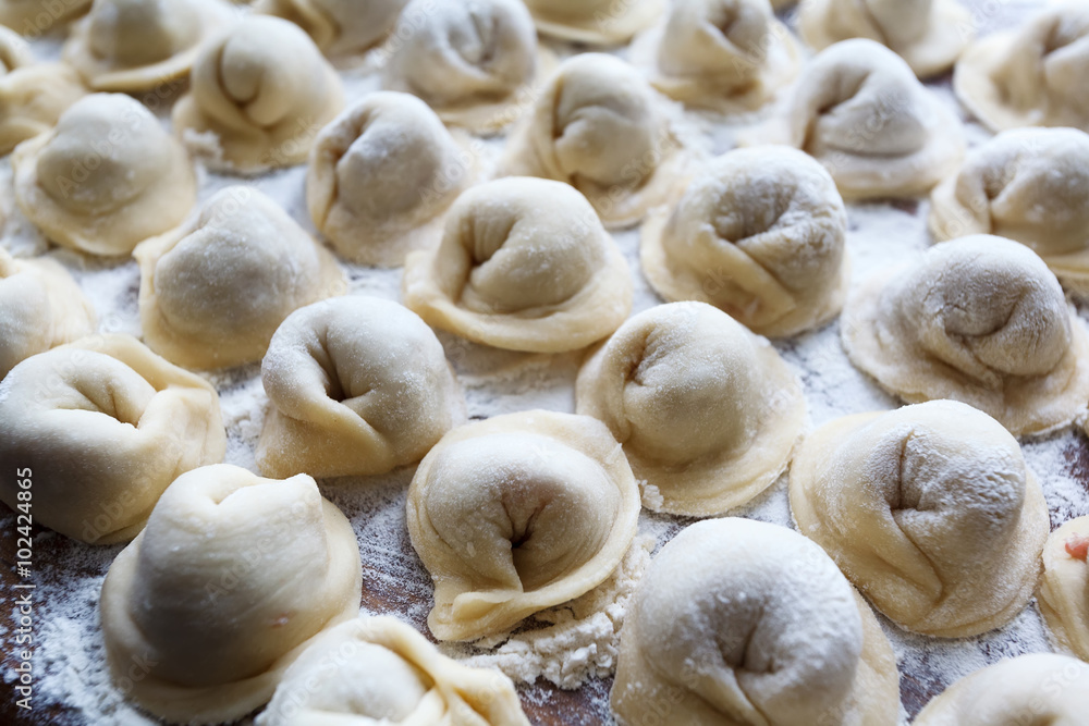 Meat dumplings russian pelmeni on wooden background Meat dumplings russian pelmeni on wooden background