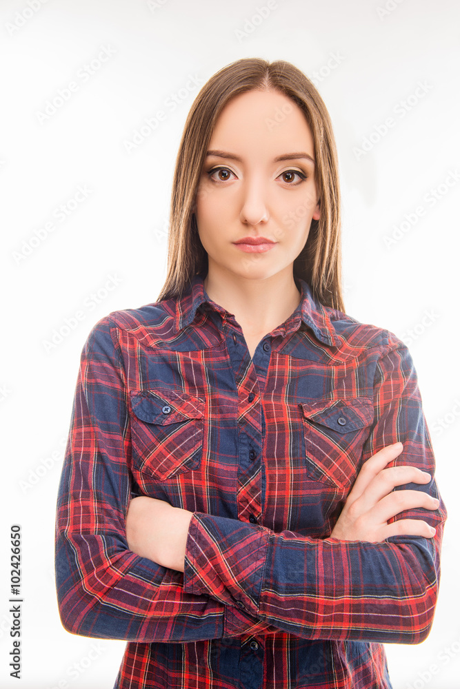 pretty serious young woman in shirt crossed her arms pretty serious young woman in shirt crossed her arms
