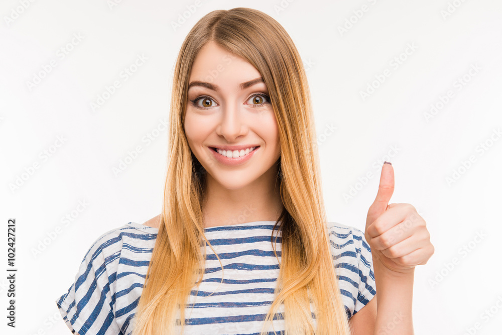 Cheerful girl showing thumbs up and smiling Cheerful girl showing thumbs up and smiling