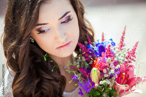 Closeup portrait of young girl with spring flowers