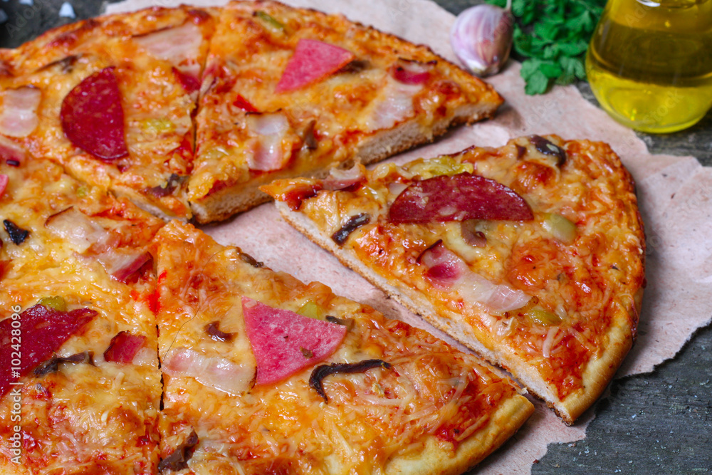 close-up Delicious Meat Pizza with Ham, Bacon and sausages on the wooden background