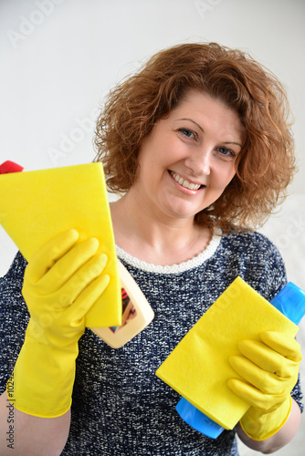 happy woman in rubber gloves with cleaning agents photo