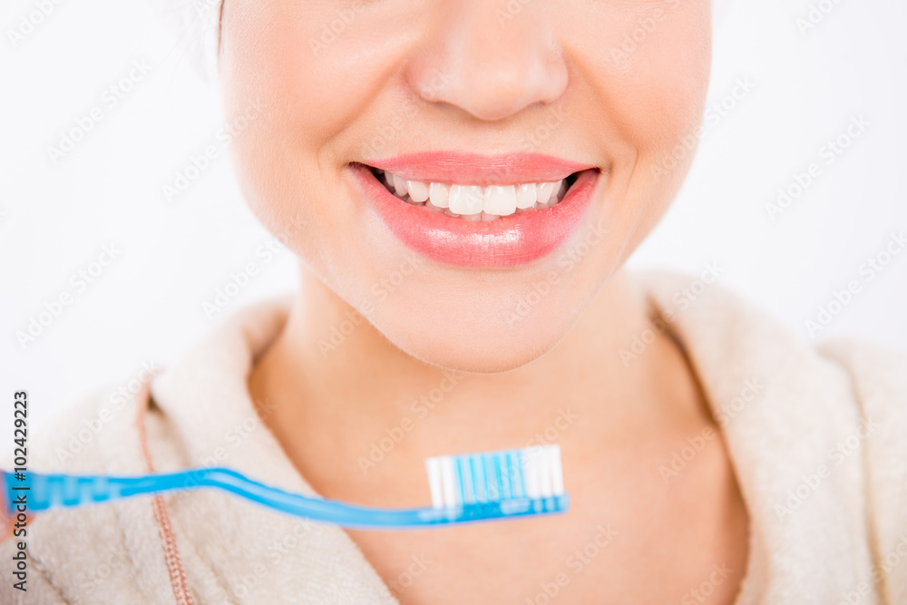 Closeup photo of young girl smiling with perfect white teeth an Closeup photo of young girl smiling with perfect white teeth an