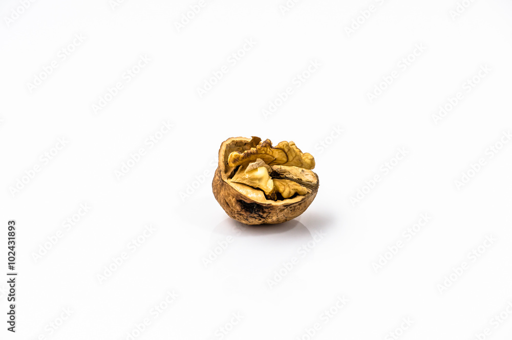 Cracked walnut on a white background. Cracked walnut on a white background.