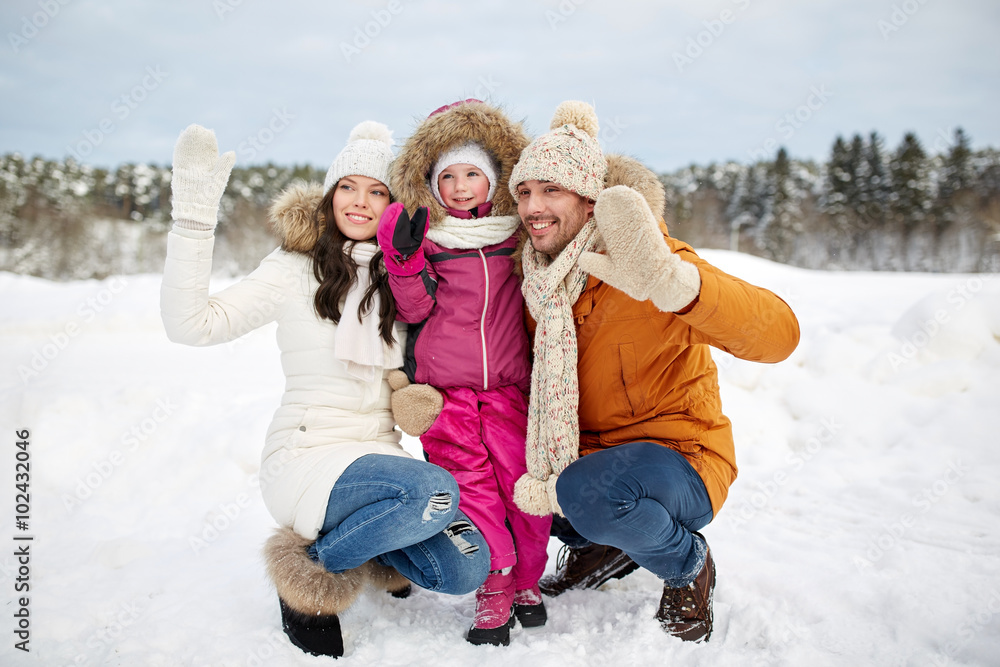 happy family waving hands outdoors in winter happy family waving hands outdoors in winter