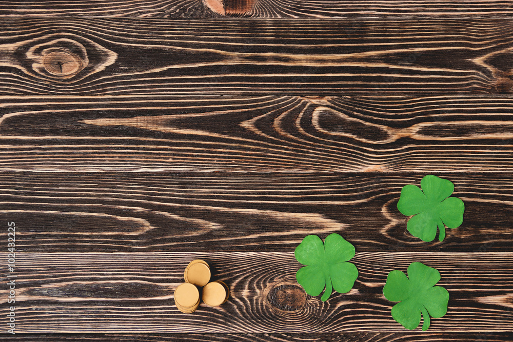 Clover leaf and coins, close-up Clover leaf and coins, close-up