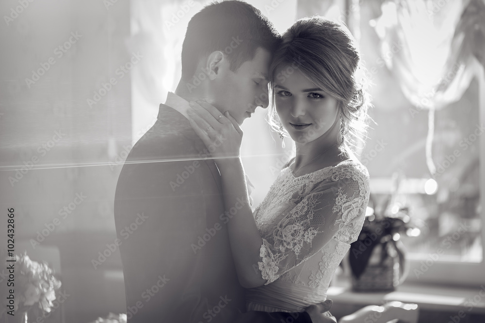 Naklejka premium Bride and groom kissing in a church after wedding ceremony