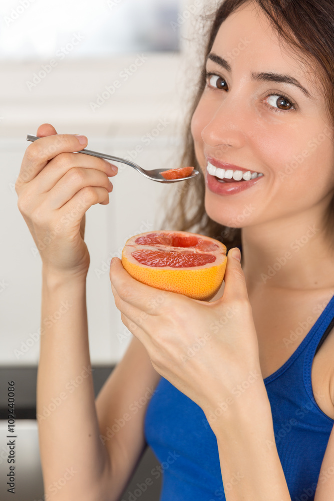 Woman eating fresh and healthy grapefruit Woman eating fresh and healthy grapefruit