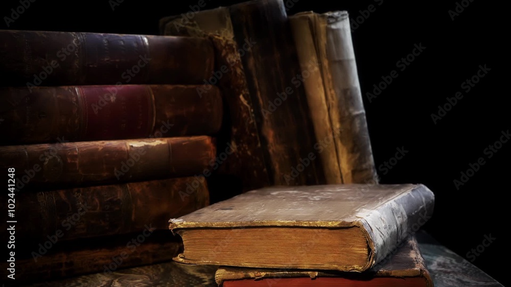 Old, aged and weathered books in a stack. Camera movement round them. Old, aged and weathered books in a stack. Camera movement round them.