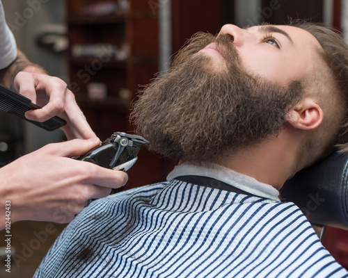 Handsome man with a long mustache in barbershop