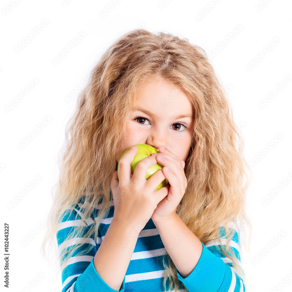 Beautiful blond little girl with long curly hair eating green apple, isolated on white background Beautiful blond little girl with long curly hair eating green apple, isolated on white background