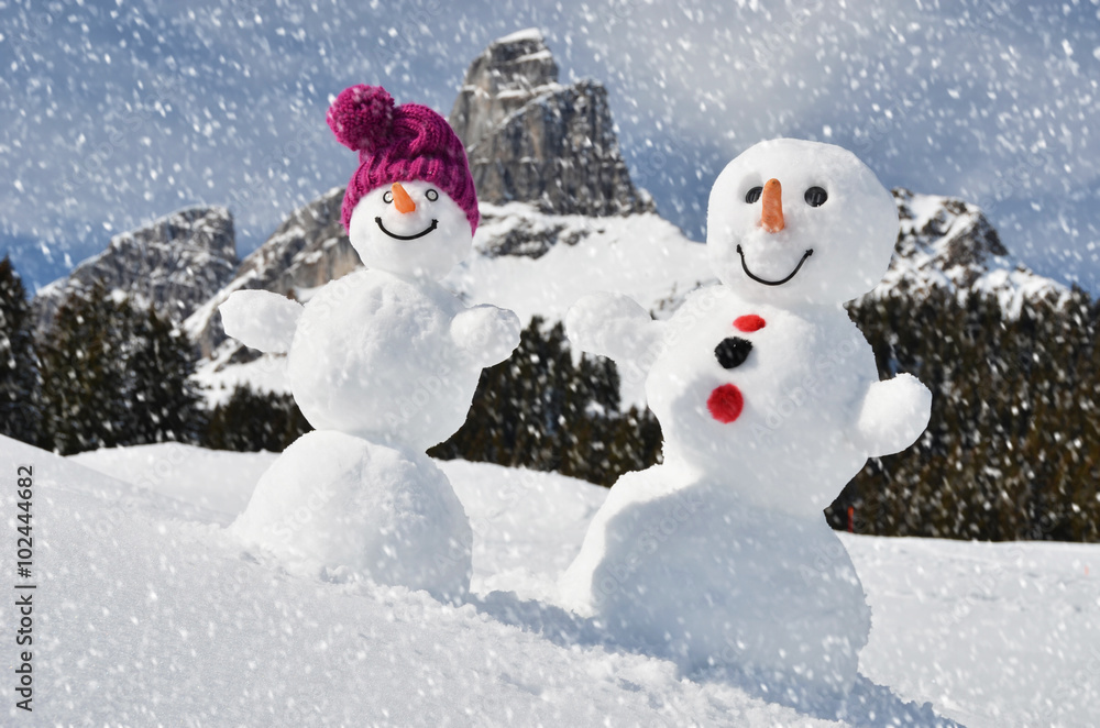 Funny snowmen against Swiss Alps Funny snowmen against Swiss Alps