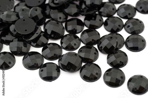 Black rhinestone on white background