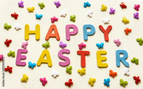 Text of colorful letters Happy Easter on the background of multicolored butterflies