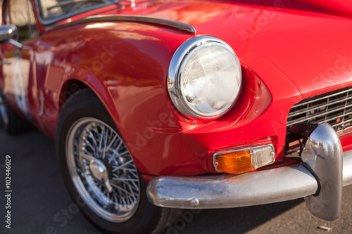 Close up detail of a red vintage car © dechevm