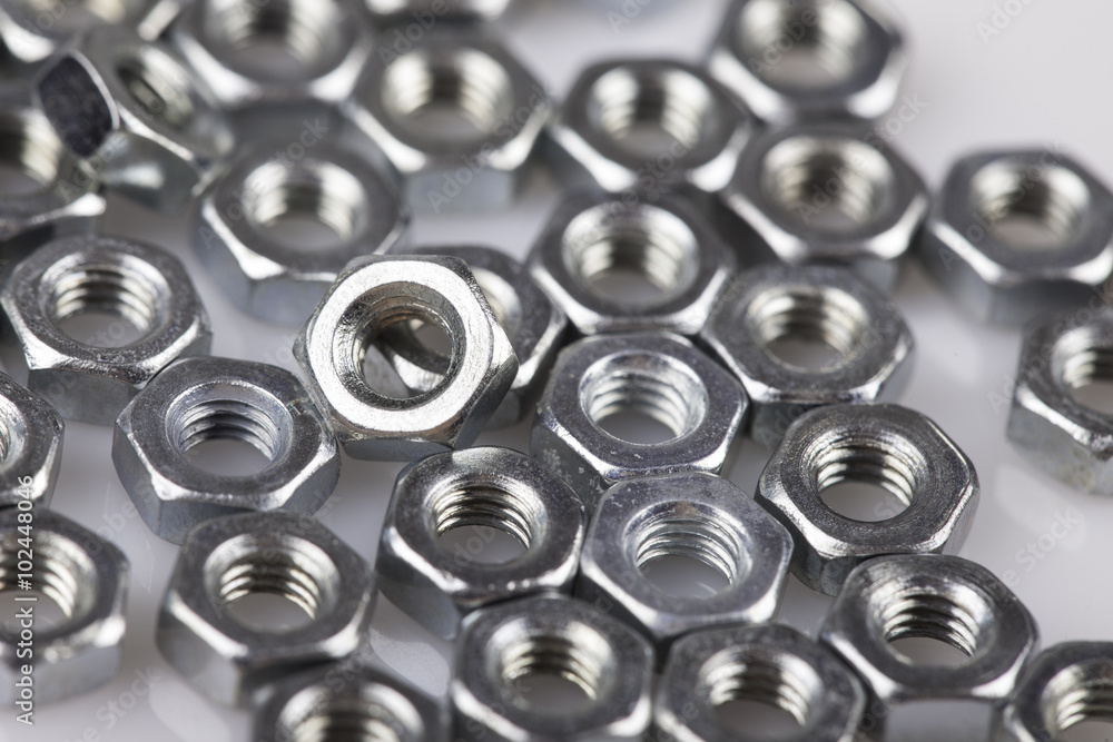 abstract background metal nuts closeup on white abstract background metal nuts closeup on white
