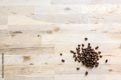 roasted coffee grain on a raw oak table