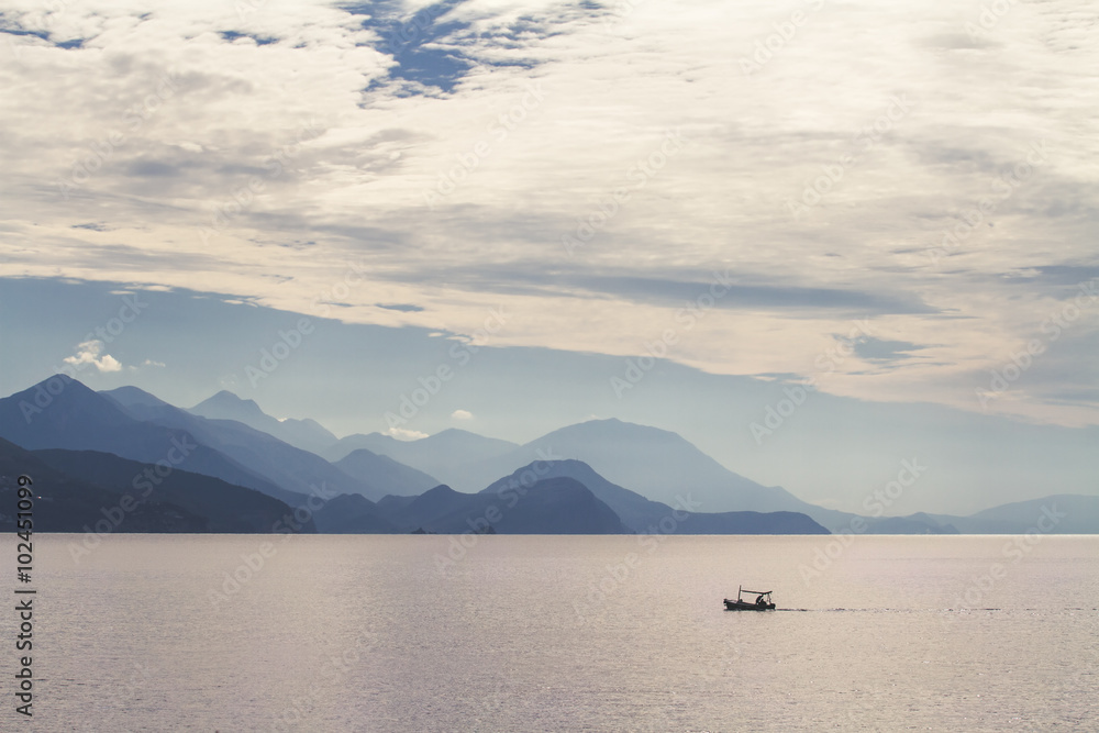 Sea, mountains and a fishermen boat.