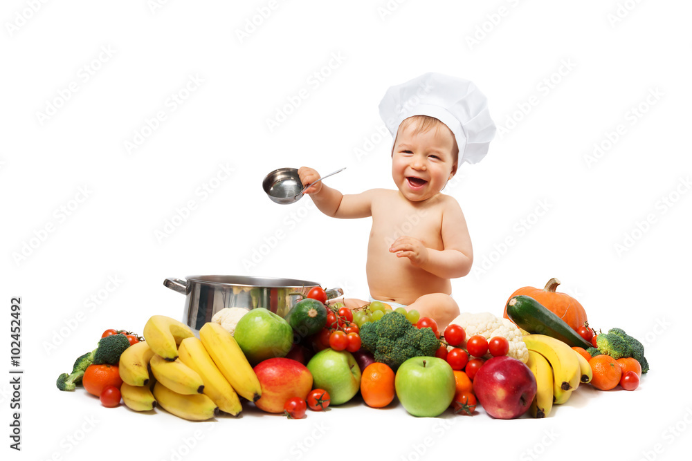 Baby boy in chef hat with cooking pan and vegetables Baby boy in chef hat with cooking pan and vegetables