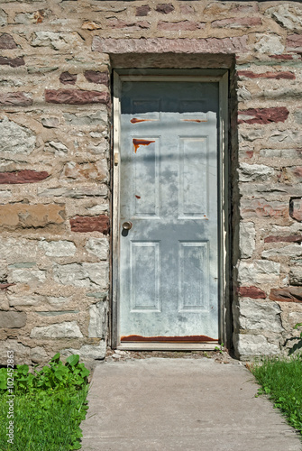 Old Metal Door in Vintage House of Stone