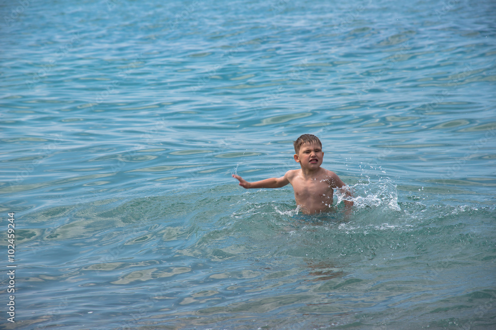 Child playing in the waves