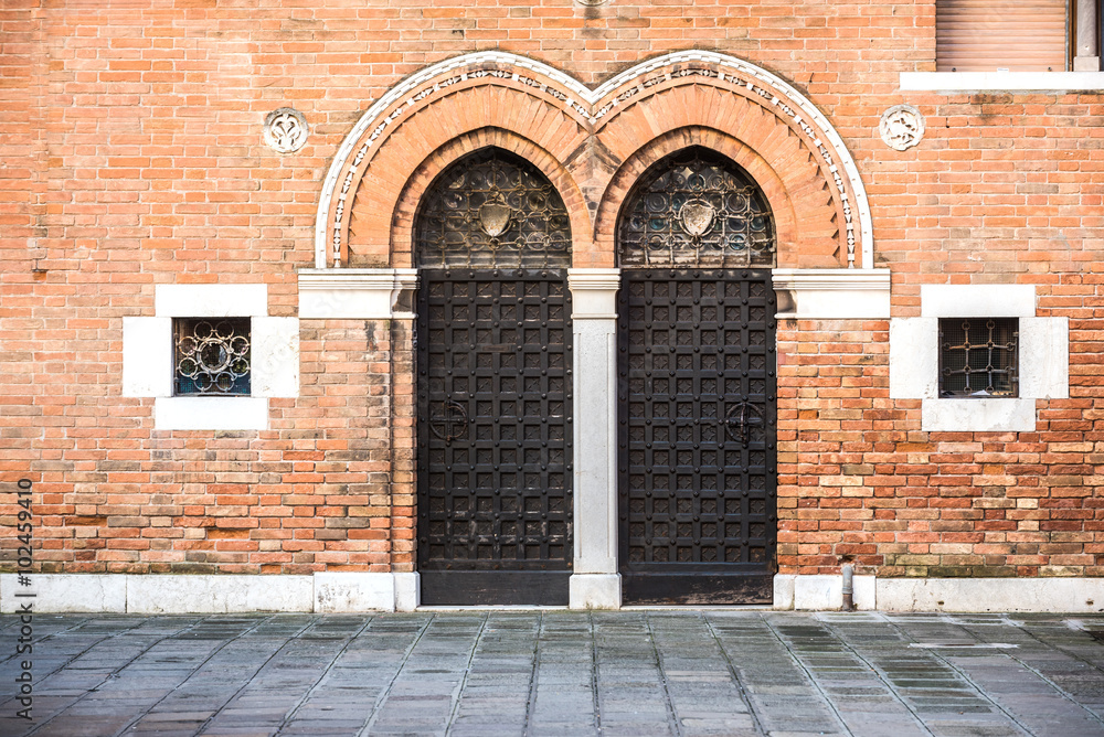 Double access doors in the medieval city of Venice. Double access doors in the medieval city of Venice.