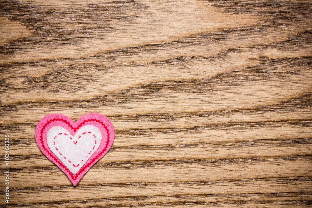 Pink fiber heart on wooden surface. Pink fiber heart on wooden surface.