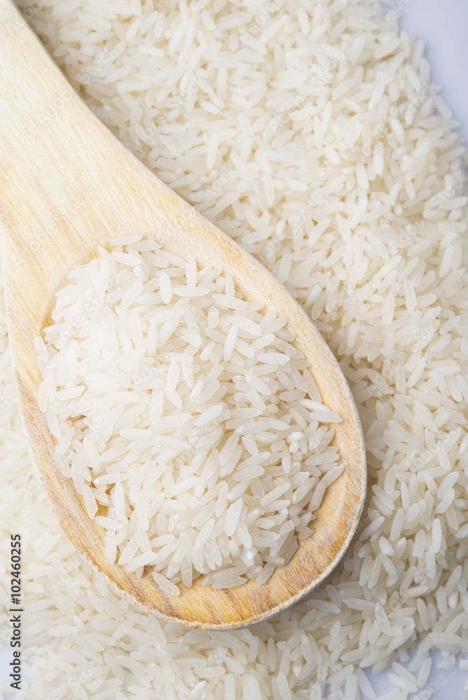 food background. brown rice in a wooden spoon. top view food background. brown rice in a wooden spoon. top view