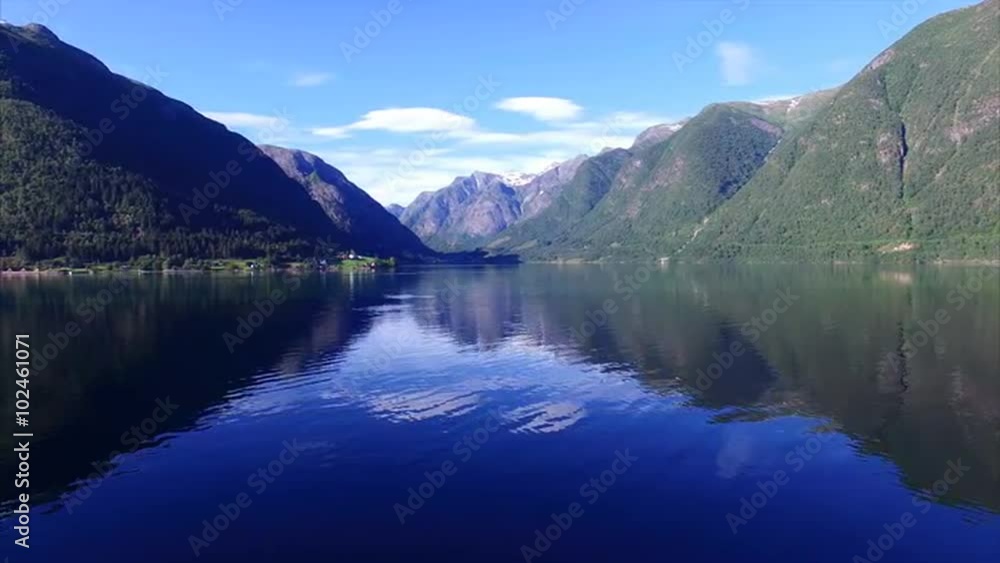 Flying above the water of deep fjord surrounded by beautiful mountains, Sognefjorden in Norway. Aerial 4k Ultra HD. Flying above the water of deep fjord surrounded by beautiful mountains, Sognefjorden in Norway. Aerial 4k Ultra HD.