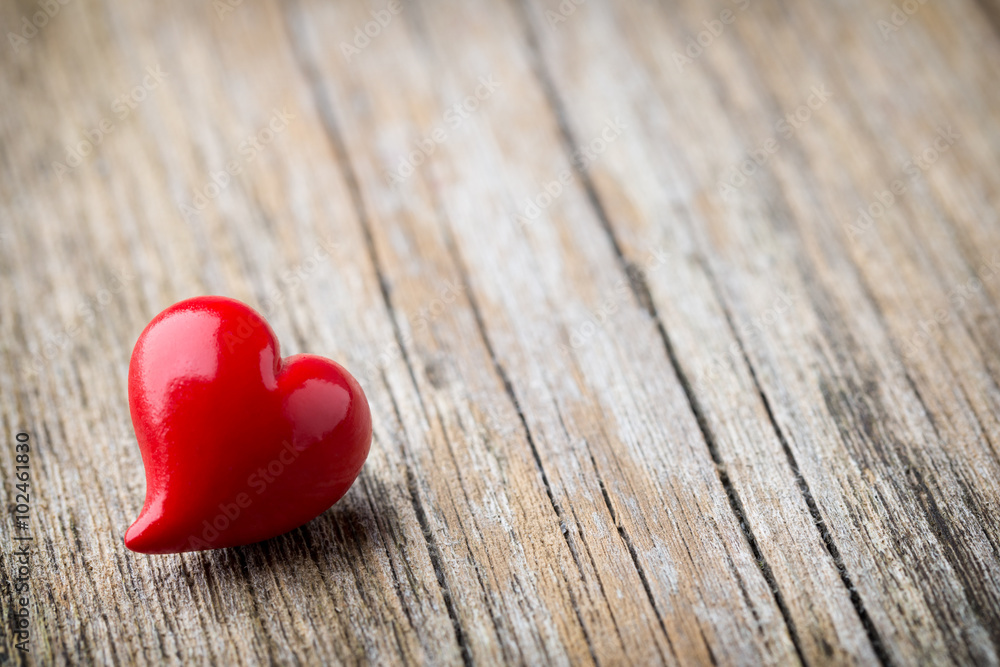 Red heart-shaped on a wooden background.