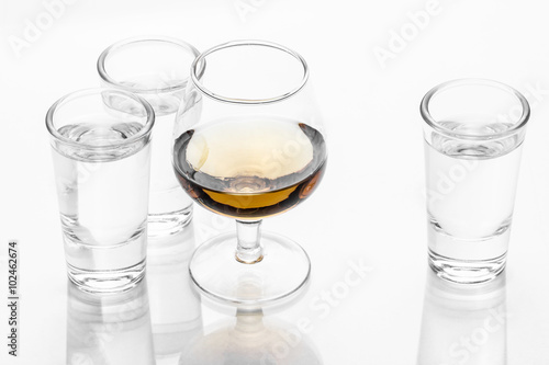 Vodka shot glass and cognac glass isolated on white.