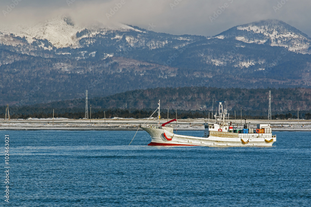 fishing boat on background of winter mountains fishing boat on background of winter mountains