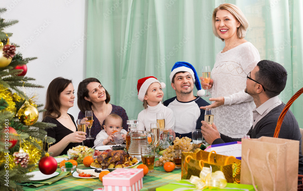 Happy mature parents with kids  celebrating Merry Christmas