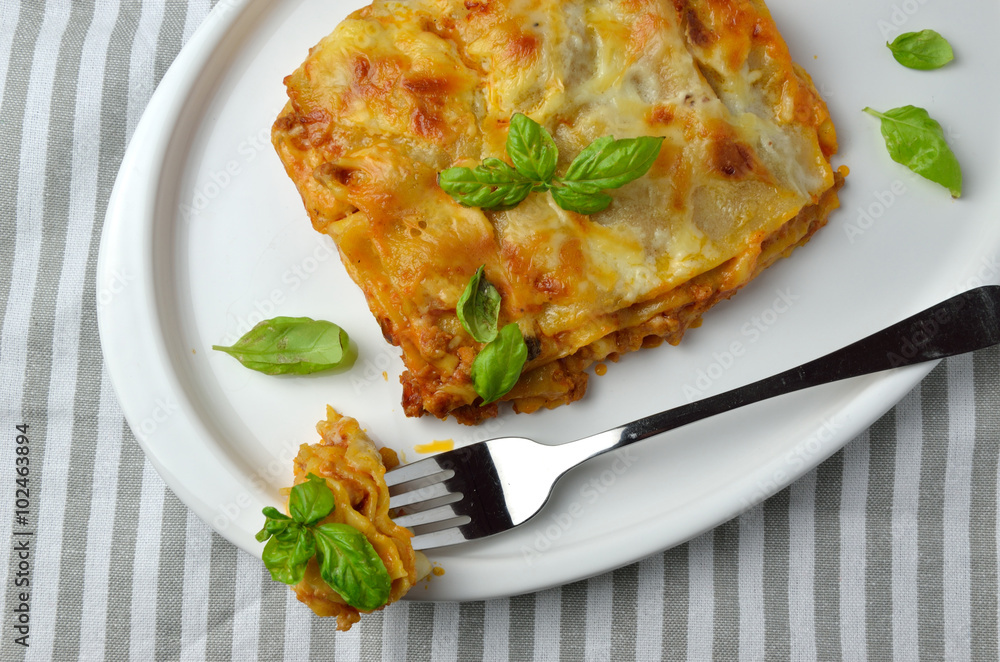 Juicy Lasagne and Leaves of Basil on Plate Juicy Lasagne and Leaves of Basil on Plate