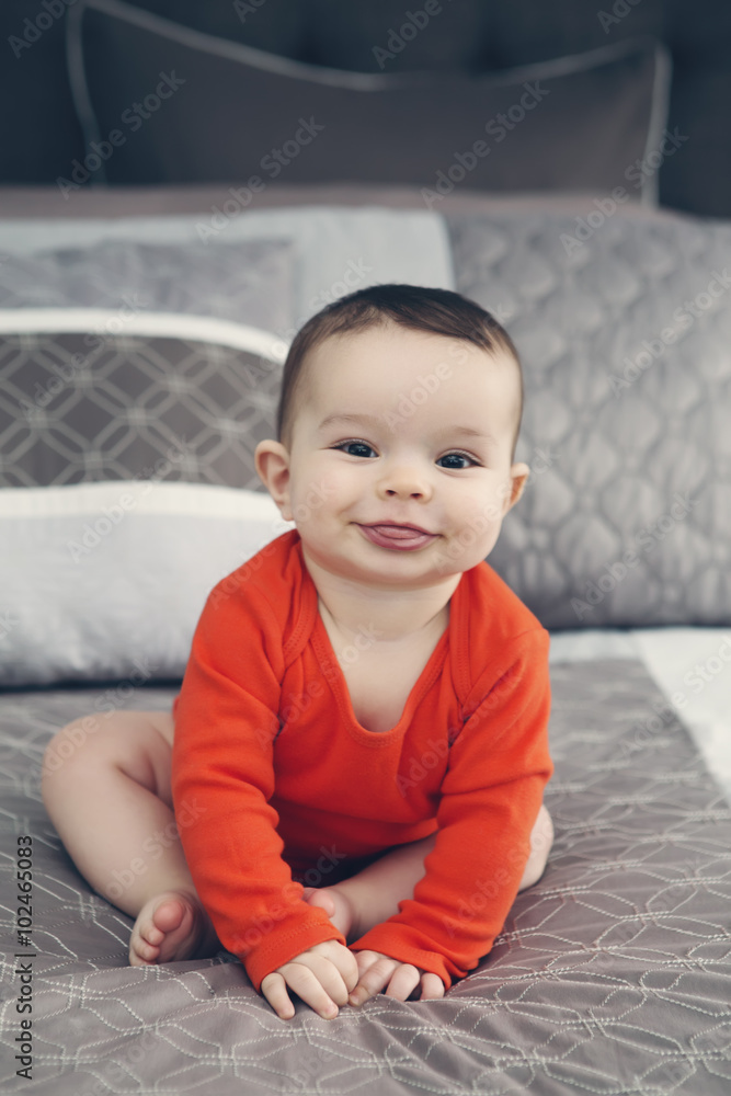 Portrait of cute adorable Caucasian baby boy with black eyes in