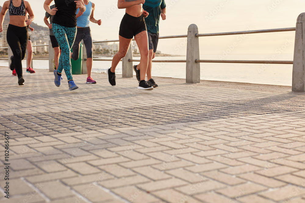 Fototapeta premium People running on street by the sea