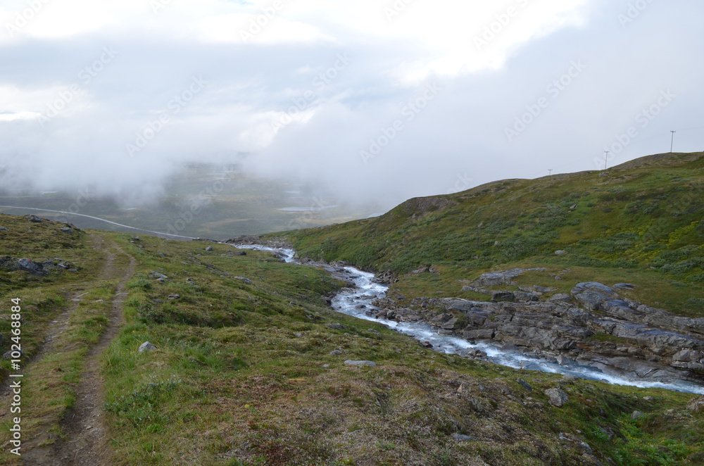 River and hiking trail in mountain valley, subarctic tundra, Swedish Lapland