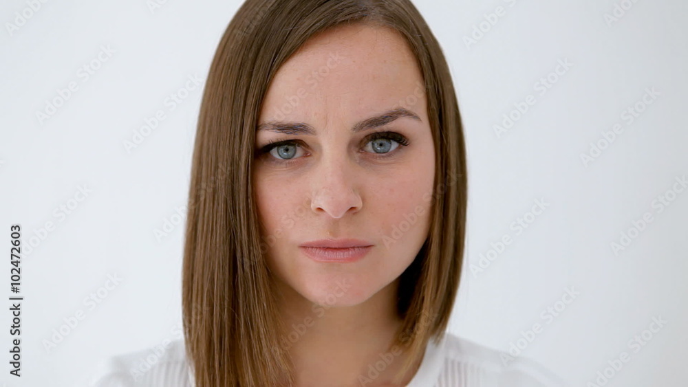 Woman, out of focus at background, comes to focus walking and stands with a disgusted gesture Woman, out of focus at background, comes to focus walking and stands with a disgusted gesture