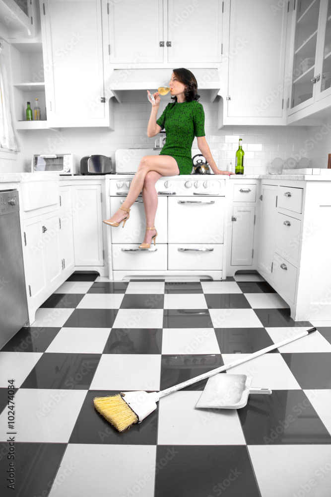 Independent woman rejects cleaning kitchen house takes a break decides to be lazy with bottle of wine Independent woman rejects cleaning kitchen house takes a break decides to be lazy with bottle of wine
