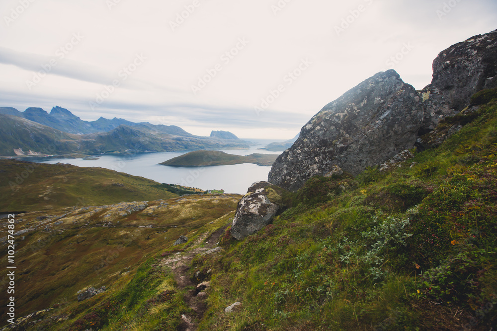 Obraz premium Classic norwegian scandinavian summer mountain landscape view with mountains, fjord, lake with a blue sky, Norway, Lofoten Islands