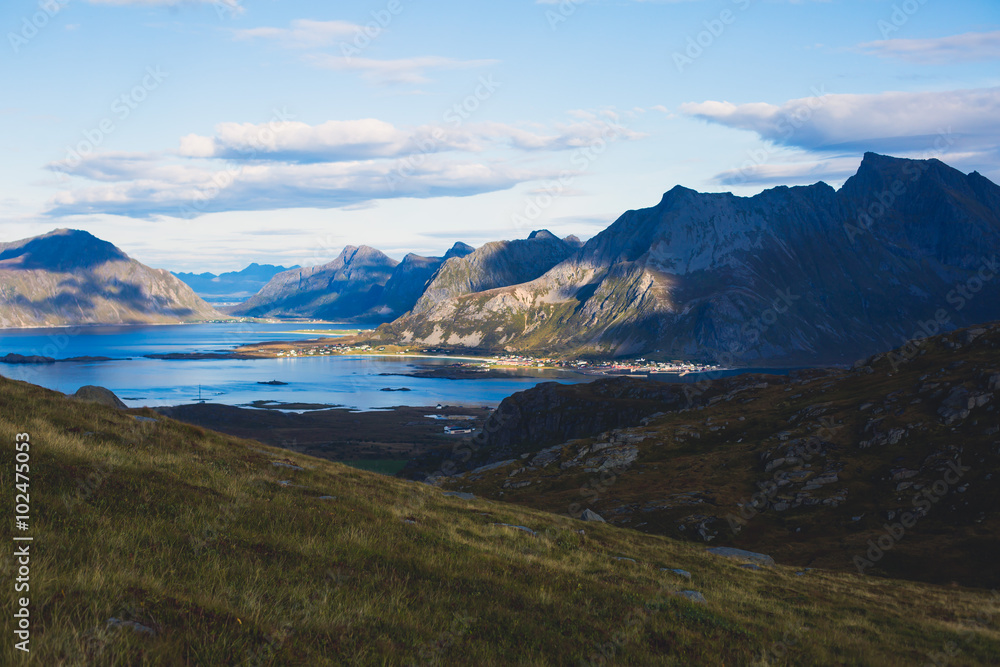 Classic norwegian scandinavian summer mountain landscape view with mountains, fjord, lake with a blue sky, Norway, Lofoten Islands