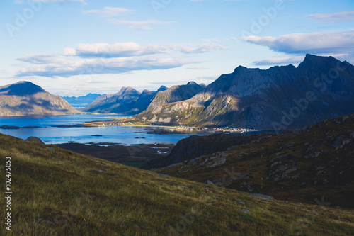 Classic norwegian scandinavian summer mountain landscape view with mountains, fjord, lake with a blue sky, Norway, Lofoten Islands