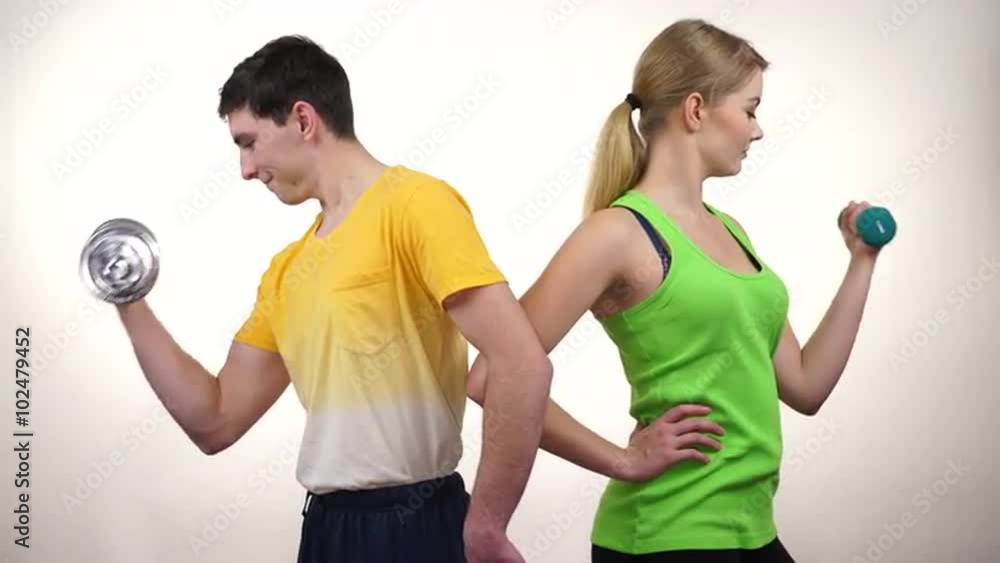 Couple exercising with dumbbells lifting weights 4K Couple exercising with dumbbells lifting weights 4K
