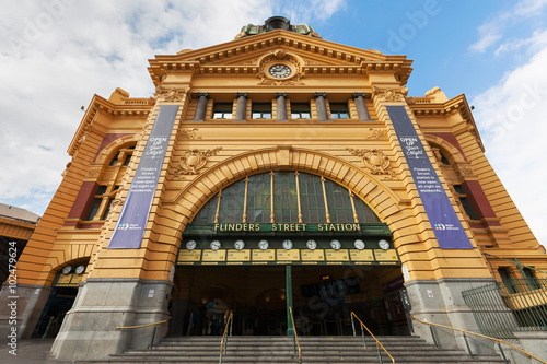 Main entrance of Flinders Street Station in Melbourne with clocks showing departure times for trains. No people present in the photograph.
