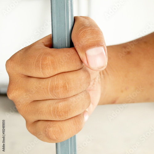 hands behind bars