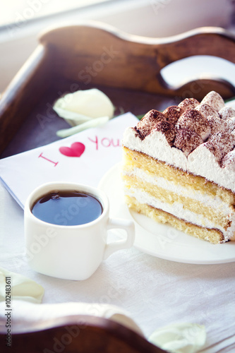 Coffee and tiramisu on the tray 