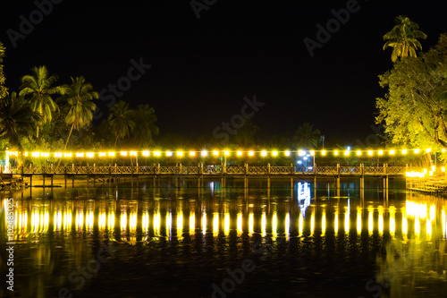 Night view of bridge decorated with lanterns.