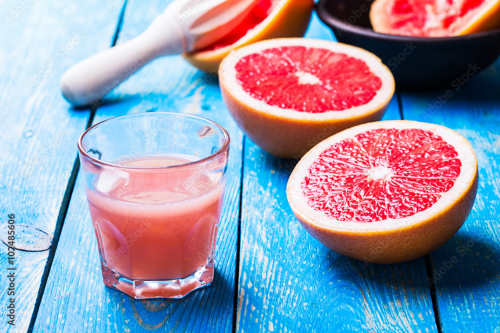 Grapefruit juice and fresh fruits on wooden table Grapefruit juice and fresh fruits on wooden table