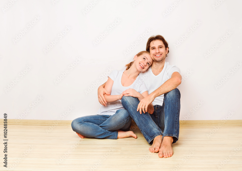 Concept: housing and mortgage for young families. couple on emp Concept: housing and mortgage for young families. couple on emp